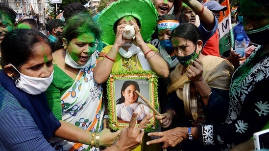 TMC supporters celebrating the party's victory in the election, in Kolkata on May 2. Riding on a mix of welfare delivery, Bengali sub-nationalism, Banerjee’s own popularity and her connect with the grassroots, the TMC won — but Banerjee lost her own fiercely fought assembly battle in Nandigram, to her former colleague and aide-turned-BJP leader Suvendu Adhikari. The TMC has sought a recount.(ANI )