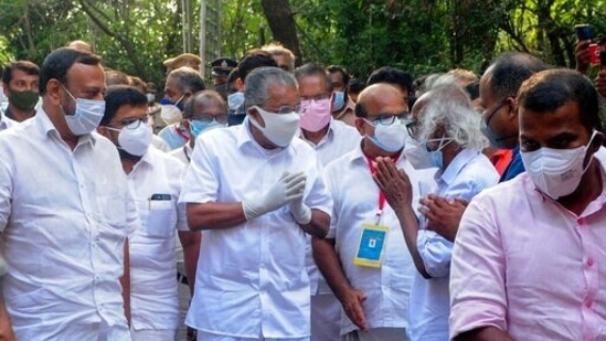 Kerala Chief Minister Pinarayi Vijayan greets other leaders and supporters as he arrives at a vote counting centre following LDF’s victory in the polls, in Kannur on May 2. Political observers in the state attributed the win to the government’s focused management of Covid-19 and Nipah, as well as floods, during its term, HT reported.(SK Mohan / AP)