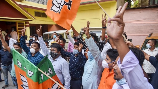 BJP workers celebrating the party’s victory in the Assam Assembly elections, in Guwahati on May 2. The BJP had reason to smile in Assam — where it returned to power despite a united opposition for a second time — under the leadership of chief minister Sarbananda Sonowal and Himanta Biswa Sarma.(PTI)