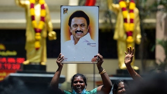 A member of Dravida Munnetra Kazhagam (DMK) holds a placard with the image of DMK leader M.K. Stalin during celebrations for the DMK results on the 2021 Tamil Nadu Legislative Assembly election, at the party headquarters in Chennai on May 2, 2021. (AFP)