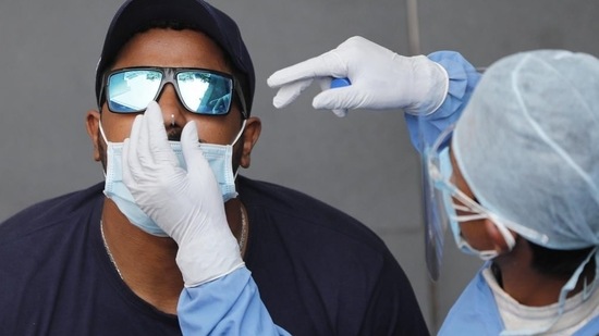 File photo: A health worker collect nasal swab for Covid-19 testing. (AP) File photo: A health worker collect nasal swab for Covid-19 testing. (AP)