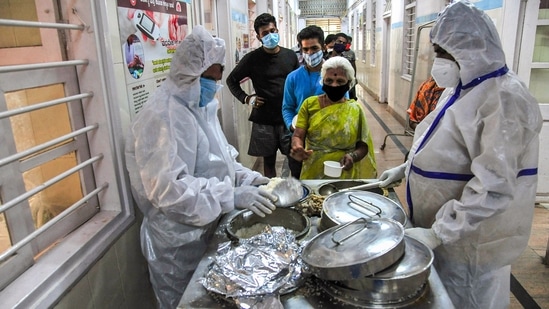 Health workers serve food to Covid-19 patients, during the second wave of the coronavirus pandemic in Bengaluru, Friday, April 30, 2021. (PTI) Health workers serve food to Covid-19 patients, during the second wave of the coronavirus pandemic in Bengaluru, Friday, April 30, 2021. (PTI)