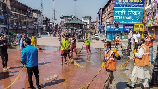 Srinagar Municipal Corporation (SMC) disinfect and clean a road to tackle the coronavirus pandemic at Lal Chowk on Monday. Srinagar Municipal Corporation (SMC) disinfect and clean a road to tackle the coronavirus pandemic at Lal Chowk on Monday.