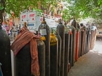 People wait to refill their medical oxygen cylinders for the Covid-19 coronavirus patients under home quarantine at a private refill center in New Delhi on May 4, 2021, as India's total Covid caseload soared past 20 million. (Photo by Prakash SINGH / AFP) People wait to refill their medical oxygen cylinders for the Covid-19 coronavirus patients under home quarantine at a private refill center in New Delhi on May 4, 2021, as India's total Covid caseload soared past 20 million. (Photo by Prakash SINGH / AFP)