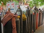 People wait to refill their medical oxygen cylinders for Covid-19 patients in Delhi on May 4, 2021, People wait to refill their medical oxygen cylinders for Covid-19 patients in Delhi on May 4, 2021,