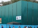 Pedestrians wearing walk past the construction site for the new Parliament building, part of the Central Vista redevelopment project, in New Delhi. (Bloomberg)