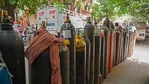 People wait to refill their medical oxygen cylinders for the Covid-19 coronavirus patients under home quarantine at a private refill center in New Delhi on May 4, 2021, as India's total Covid caseload soared past 20 million. (Photo by Prakash SINGH / AFP) People wait to refill their medical oxygen cylinders for the Covid-19 coronavirus patients under home quarantine at a private refill center in New Delhi on May 4, 2021, as India's total Covid caseload soared past 20 million. (Photo by Prakash SINGH / AFP)