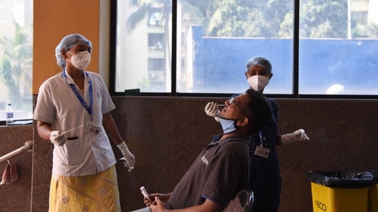 Medics take swab sample for Covid-19 testing at Meenatai Thackeray Hospital Nerul in Navi Mumbai.(Bachchan Kumar / HT Photo)