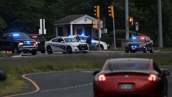 Police cars are seen outside the CIA headquarters's gate after an attempted intrusion earlier in the day in Langley, Virginia.(AFP)