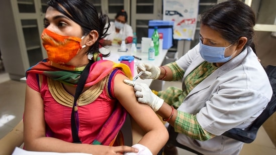 A health worker administers Covid-19 vaccine to a woman, at the Moti Lal Nehru Medical College in Prayagraj. (PTI) A health worker administers Covid-19 vaccine to a woman, at the Moti Lal Nehru Medical College in Prayagraj. (PTI)