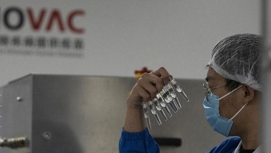 A worker inspects syringes of a vaccine for Covid-19 produced by Sinovac at its factory in Beijing (AP). A worker inspects syringes of a vaccine for Covid-19 produced by Sinovac at its factory in Beijing (AP).