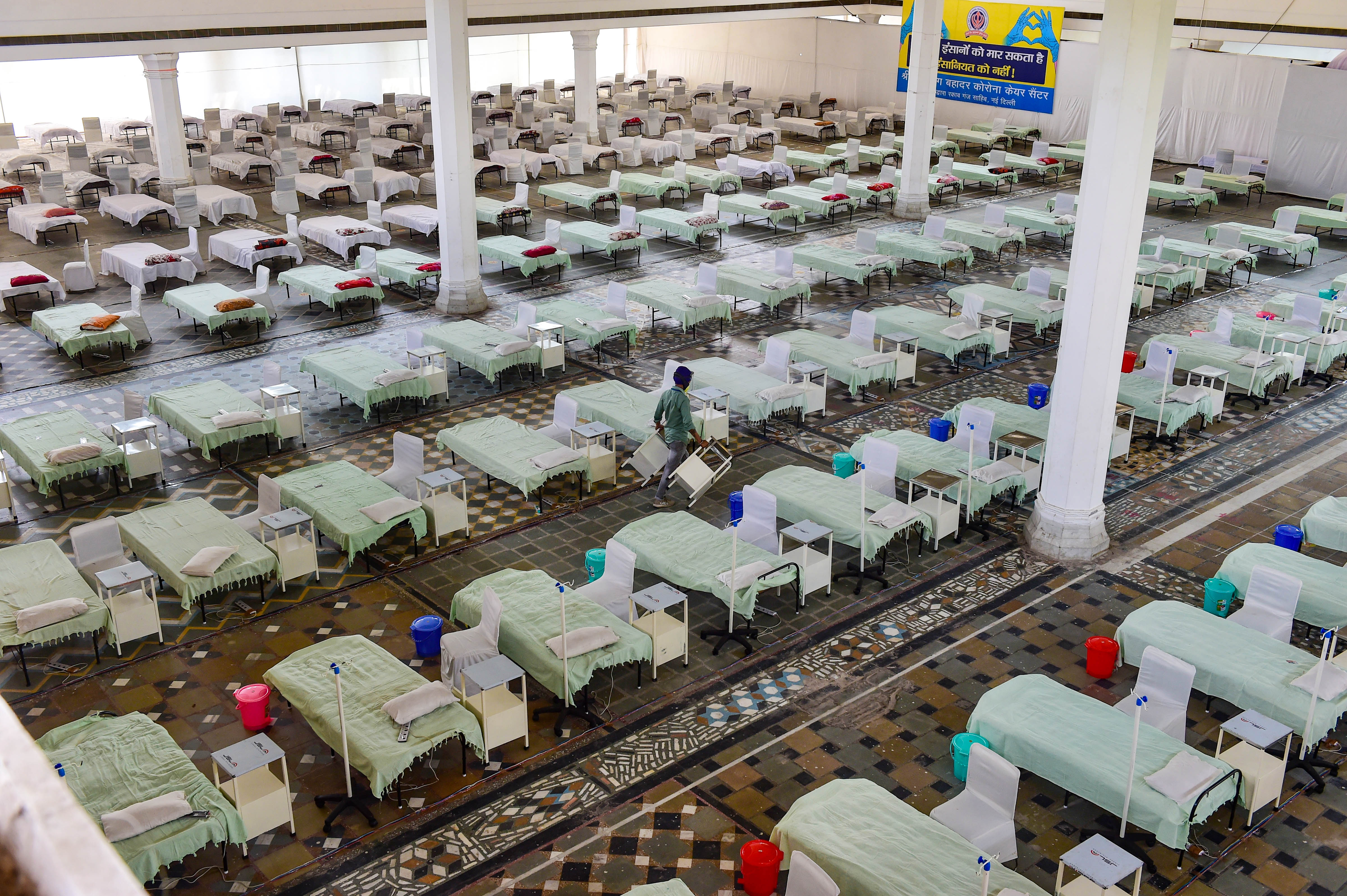 New Delhi: Volunteers set up an under-construction temporary Covid-19 Care Centre of 200 beds with oxygen support, amid the ongoing second wave of coronavirus pandemic, at Gurudwara Rakab Ganj Sahib in New Delhi, Monday, May 3, 2021. (PTI) New Delhi: Volunteers set up an under-construction temporary Covid-19 Care Centre of 200 beds with oxygen support, amid the ongoing second wave of coronavirus pandemic, at Gurudwara Rakab Ganj Sahib in New Delhi, Monday, May 3, 2021. (PTI)