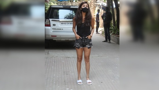 To add a pop to her all-black look, she styled it with a pair of white slides. (Varinder Chawla)