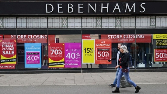 Signs in the window of a closing Debenhams store offer sales bargains on the High Street in Winchester, south west England on March 31, 2021. (AFP)