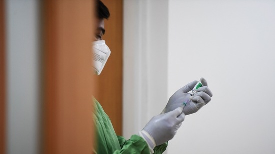 A healthcare worker readies for vaccinating a beneficiary. (AFP/For Representative Purposes Only) A healthcare worker readies for vaccinating a beneficiary. (AFP/For Representative Purposes Only)
