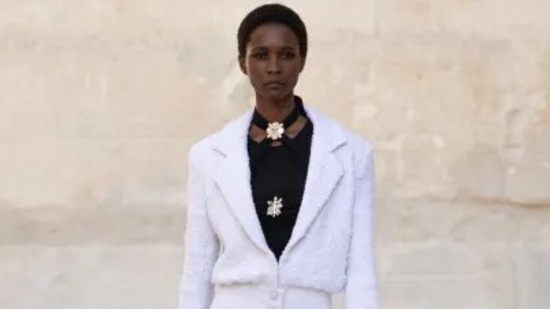 In bright white bouclé, Virginie Viard reinterprets the tweed jacket with a buttoned peplum for the CHANEL Cruise 2021/22 collection, layered over a deep black ensemble for a modern play on classic contrasts. (Chanel website) In bright white bouclé, Virginie Viard reinterprets the tweed jacket with a buttoned peplum for the CHANEL Cruise 2021/22 collection, layered over a deep black ensemble for a modern play on classic contrasts. (Chanel website)
