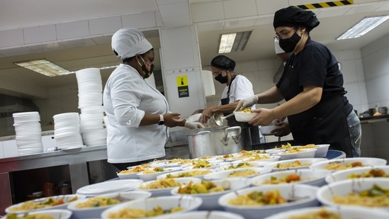 Volunteers prep cooked meals for the hungry at the Augusto Motta University Center in Rio de Janeiro, Brazil, Thursday, April 29, 2021. The volunteer group "Covid Sem Fome," or Covid Without Hunger, is using the school's gastronomy course kitchen to feed the needy. (AP Photo) Volunteers prep cooked meals for the hungry at the Augusto Motta University Center in Rio de Janeiro, Brazil, Thursday, April 29, 2021. The volunteer group "Covid Sem Fome," or Covid Without Hunger, is using the school's gastronomy course kitchen to feed the needy. (AP Photo)