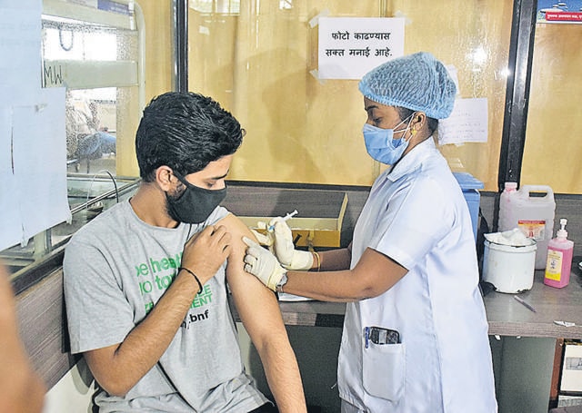 A beneficiary aged 22 gets his vaccination at the Kamala Nehru hospital, Mangalwar Peth, Pune on Tuesday. (HT PHOTO)