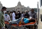Family members brought a COVID-19 patient in front of Vidhana Soudha to protest as they did not get a bed even after waiting for a long time at a government hospital in Bengaluru. The state reported close to 50,000 cases on Thursday. Family members brought a COVID-19 patient in front of Vidhana Soudha to protest as they did not get a bed even after waiting for a long time at a government hospital in Bengaluru. The state reported close to 50,000 cases on Thursday.
