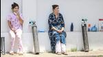 Patients, on oxygen support, wait outside the Covid-19 facility of the Chest Disease Hospital, in Jammu, Thursday. (PTI) Patients, on oxygen support, wait outside the Covid-19 facility of the Chest Disease Hospital, in Jammu, Thursday. (PTI)