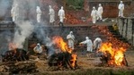Nepalese men in personal protective suits cremate the bodies of Covid-19 victims near Pashupatinath temple in Kathmandu, Nepal. (AP) Nepalese men in personal protective suits cremate the bodies of Covid-19 victims near Pashupatinath temple in Kathmandu, Nepal. (AP)