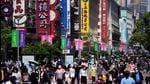 People walk along Nanjing pedestrian road, a main shopping area, during the Labour Day holidays in Shanghai, China on May 5, 2021. (REUTERS) People walk along Nanjing pedestrian road, a main shopping area, during the Labour Day holidays in Shanghai, China on May 5, 2021. (REUTERS)