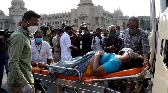 Family members brought a COVID-19 patient in front of Vidhana Soudha to protest as they did not get a bed even after waiting for a long time at a government hospital in Bengaluru. The state reported close to 50,000 cases on Thursday. (ANI Photo)