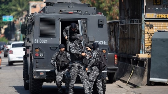 Police get out of an armored vehicle during an operation against alleged drug traffickers in Rio de Janeiro, Brazil, Thursday, May 6, 2021.(AP)