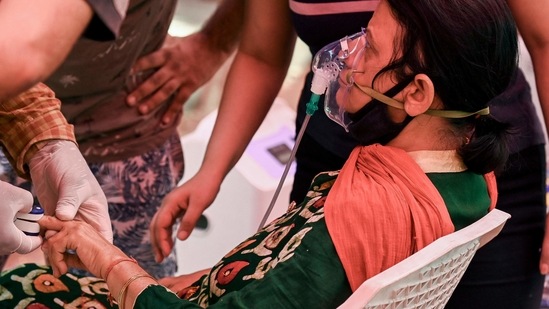 A Covid-19 patient breathes with the help of oxygen provided by a Gurdwara in Ghaziabad. (AFP)