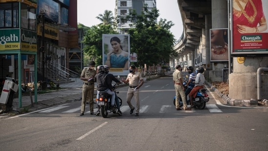 Kerala: Policemen check the credentials of commuters during a weekend lockdown last week to curb the spread of coronavirus. (AP / File Photo)