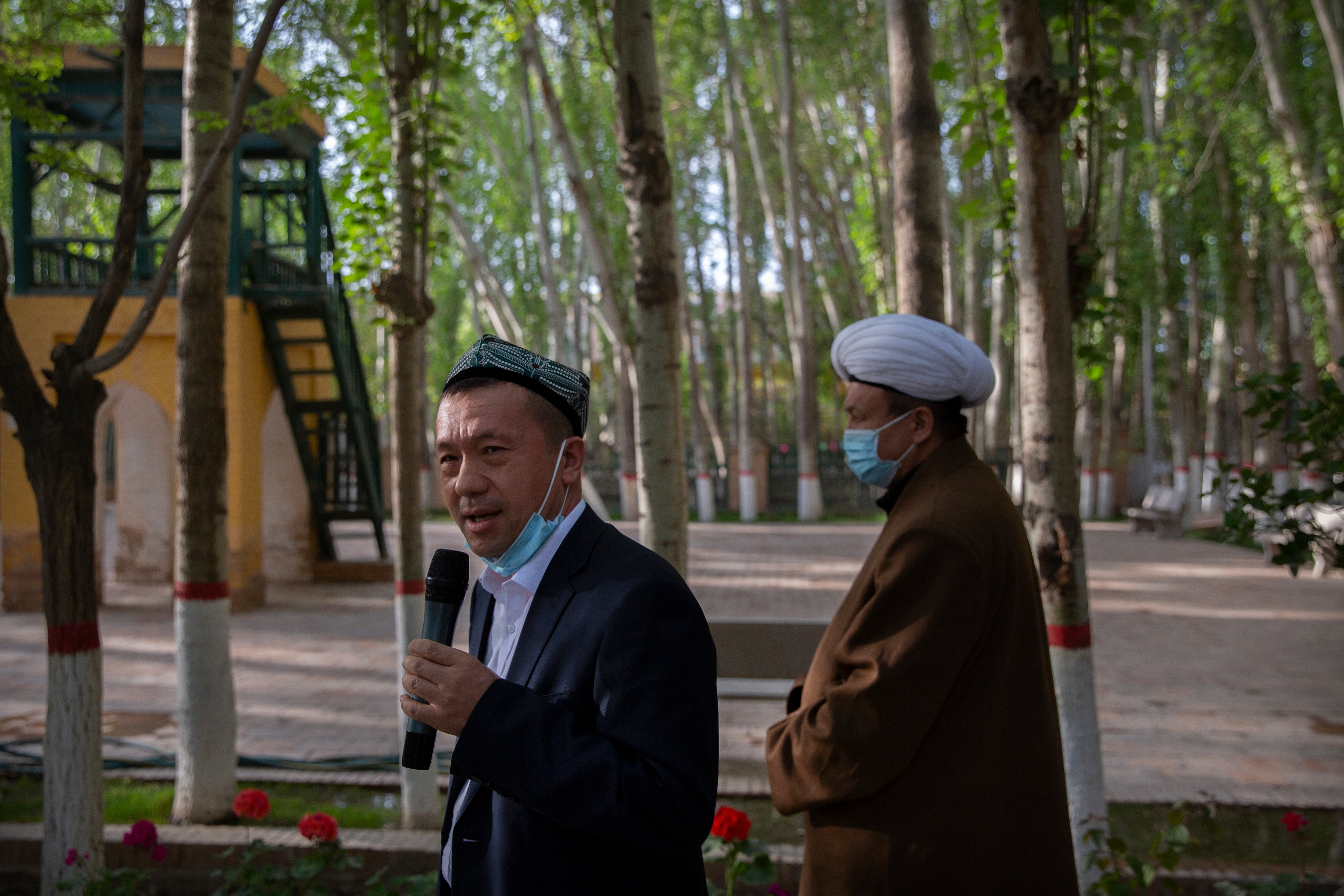 Mamat Juma, left, imam of the Id Kah Mosque, speaks to foreign journalists during a government organized visit at the mosque in Kashgar in western China's Xinjiang Uyghur Autonomous Region on April 19, 2021. (AP) Mamat Juma, left, imam of the Id Kah Mosque, speaks to foreign journalists during a government organized visit at the mosque in Kashgar in western China's Xinjiang Uyghur Autonomous Region on April 19, 2021. (AP)