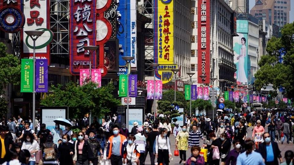 People walk along Nanjing pedestrian road, a main shopping area, during the Labour Day holidays in Shanghai, China on May 5, 2021. (REUTERS) People walk along Nanjing pedestrian road, a main shopping area, during the Labour Day holidays in Shanghai, China on May 5, 2021. (REUTERS)