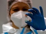 A medical worker poses with a vial of the Sinopharm's Covid-19 vaccine.(AP) A medical worker poses with a vial of the Sinopharm's Covid-19 vaccine.(AP)