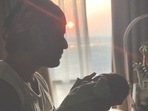 Mohit Malik holds his son as he shares his first glimpse with the world.