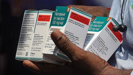 File photo: A man holds boxes of Remdesivir, an antiviral drug used to treat Covid-19 symptoms. (PTI) File photo: A man holds boxes of Remdesivir, an antiviral drug used to treat Covid-19 symptoms. (PTI)