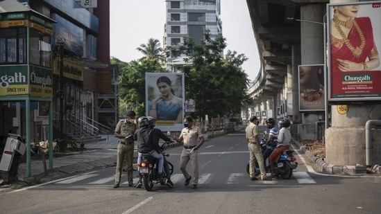 Police personnel screening commuters during a weekend lockdown in Kochi, Kerala on May 2. Kerala is at the third spot after Maharashtra and Karnataka in terms of total coronavirus cases in India.(RS Iyer / AP)