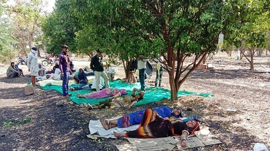 Covid-19 patients being treated at an orange farm after a shortage of space in hospital wards in Malwa, Madhya Pradesh on May 5. Chief Minister Shivraj Singh Chouhan said the only way to break the chain of transmission and contain Covid-19 cases was for people to “close down everything” till May 15, HT reported.(ANI)