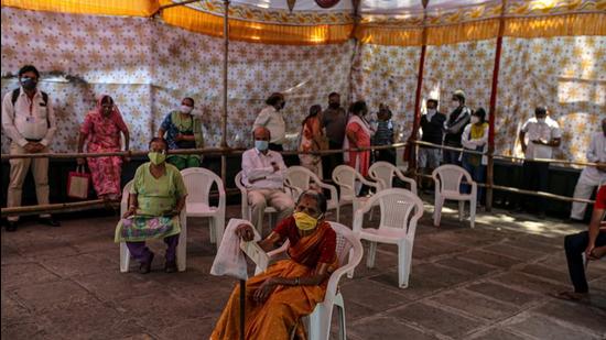 People wait at a Covid-19 vaccination center set up at a municipal hospital in Pune, Maharashtra, India, on May 5, 2021. (BLOOMBERG) People wait at a Covid-19 vaccination center set up at a municipal hospital in Pune, Maharashtra, India, on May 5, 2021. (BLOOMBERG)