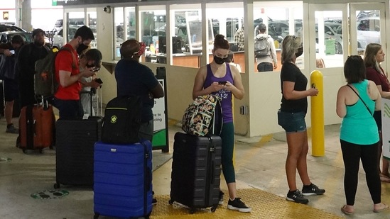 People wait in line at Enterprise rental agency in the Miami International Airport Car Rental Center in Miami, Florida. (AFP) People wait in line at Enterprise rental agency in the Miami International Airport Car Rental Center in Miami, Florida. (AFP)