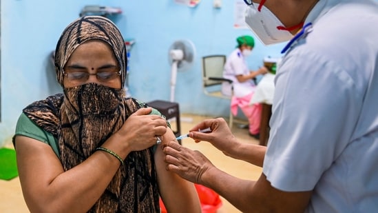 A health worker inoculates a woman with a dose of Covishield Covid-19 coronavirus vaccine at a vaccination centre in Mumbai. (AFP)