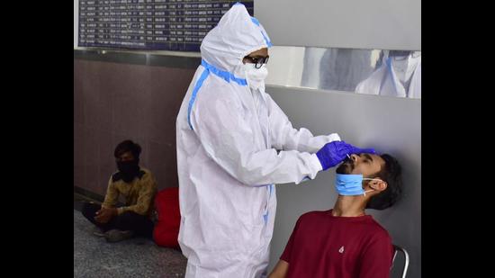 A migrant getting tested for Covid at railway station in Amritsar on Friday. (Sameer Sehgal/HT)