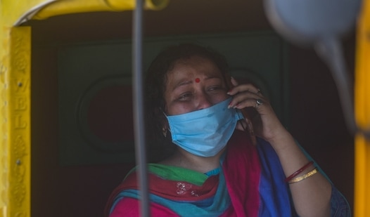 A relative of a person who died of Covid-19 in tears while speaking on the phone outside LNJP hospital in New Delhi. (Amal KS/ Hindustan Times)