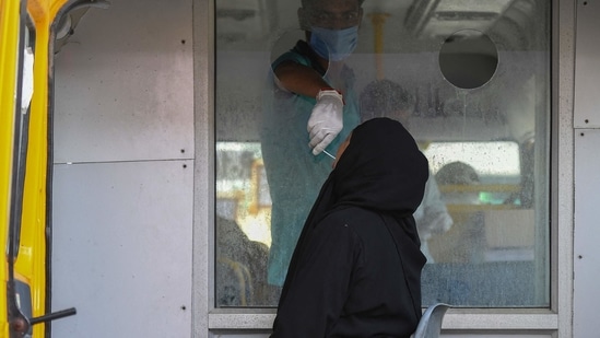 In this picture taken on May 5, 2021, a medical officer takes swab sample of a woman for Covid-19 coronavirus RT-PCR test in Moradabad. (AFP) In this picture taken on May 5, 2021, a medical officer takes swab sample of a woman for Covid-19 coronavirus RT-PCR test in Moradabad. (AFP)