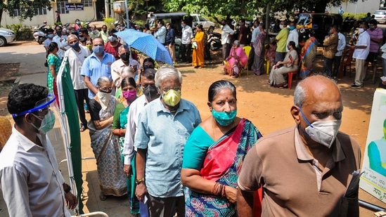 Civilians wait in a queue to get vaccinated against coronavirus in Chikmagalur. (PTI Photo)