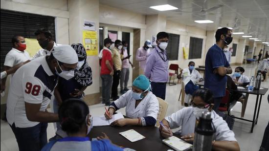 Indians register to receive the vaccine for COVID-19 at a medical college in Prayagraj, India, on Saturday. (AP)