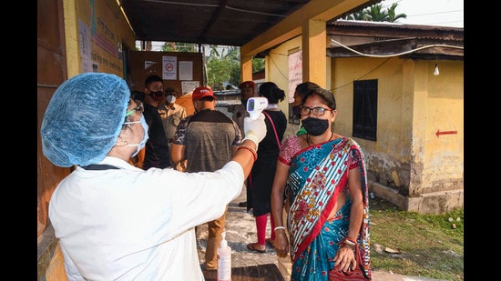 Voters being screened for Covid-19 symptoms at a polling booth, Guwahati, April 6, 2021 (PTI)
