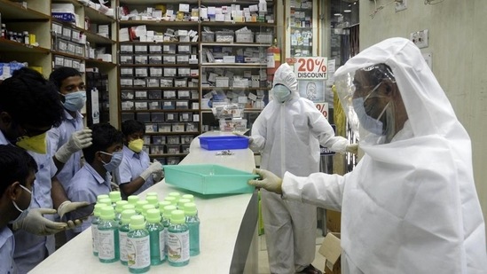 Pharmacy shop workers wear full protective gear suits during the nationwide lockdown to curb the spread.(ANI)