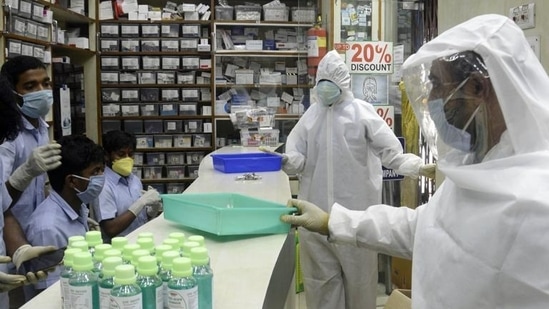 Pharmacy shop workers wear full protective gear suits during the nationwide lockdown to curb the spread of coronavirus. (ANI)