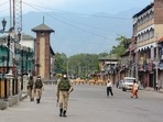 Security personnel patrol on a deserted street during Covid-induced curfew in Srinagar. Security personnel patrol on a deserted street during Covid-induced curfew in Srinagar.