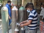 A worker refills oxygen cylinders for Covid-19 patients at a oxygen filling centre, in New Delhi on Sunday. A worker refills oxygen cylinders for Covid-19 patients at a oxygen filling centre, in New Delhi on Sunday.